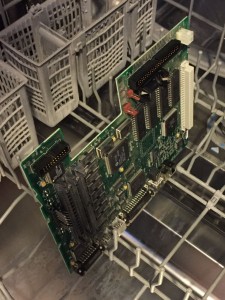 Macintosh LC II/Performa 410 logic board on lower rack of a common dishwasher ready for a cleaning.