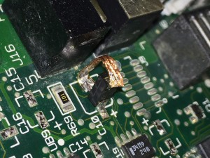 Closeup of capacitor 10 repair on Performa 410 motherboard.