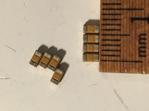 Super closeup of the capacitors with ruler for scale.
