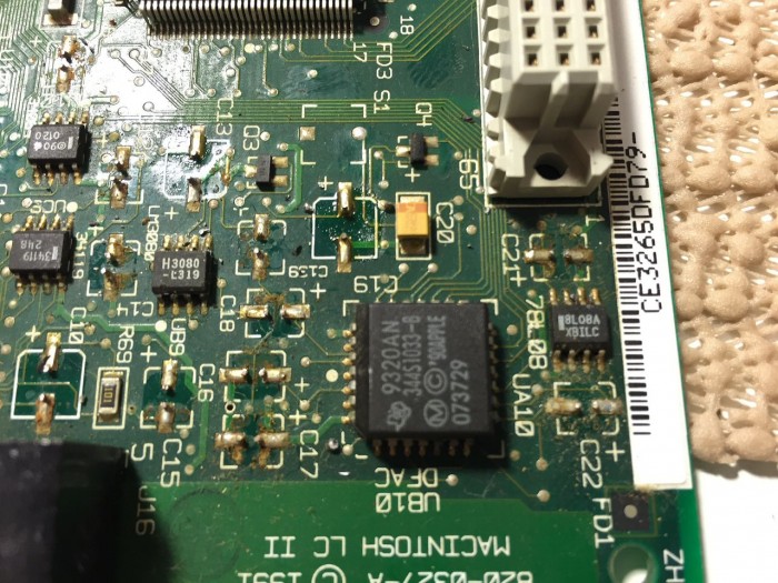 Macintosh LC II/Performa 410 closeup of leaking electrolyte after capacitor removal.